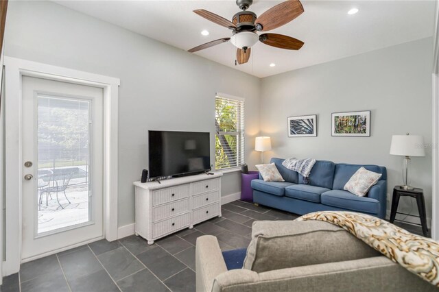 2250 Davis Dr, New Smyrna Beach, FL 32168 - living room with dark tile patterned floors, a ceiling fan, and recessed lighting
