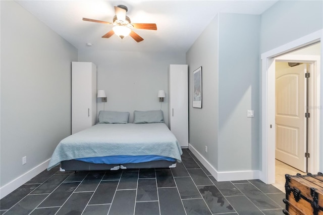 2250 Davis Dr, New Smyrna Beach, FL 32168 - bedroom with dark tile patterned flooring and a ceiling fan