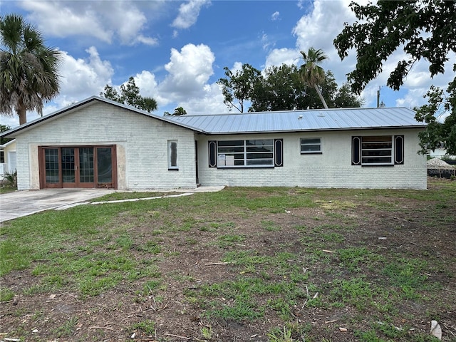 1018 Albin St, Cocoa, FL 32927 - view of front of property featuring brick siding, metal roof, and a front lawn