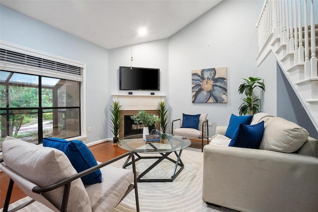 940 Douglas Ave Unit 189, Altamonte Springs, FL 32714 - living area featuring vaulted ceiling, wood finished floors, a fireplace, and stairs