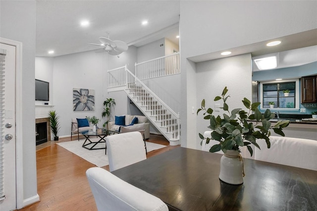 940 Douglas Ave Unit 189, Altamonte Springs, FL 32714 - dining area featuring a tiled fireplace, stairs, light wood-type flooring, recessed lighting, and ceiling fan