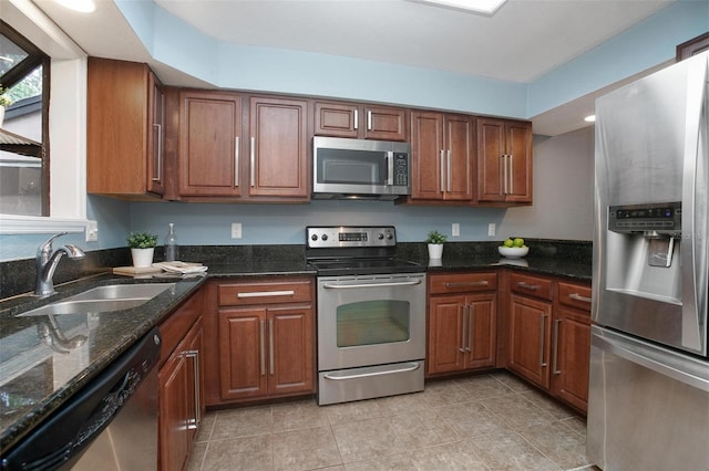 940 Douglas Ave Unit 189, Altamonte Springs, FL 32714 - kitchen featuring appliances with stainless steel finishes, light tile patterned floors, dark stone countertops, brown cabinets, and recessed lighting