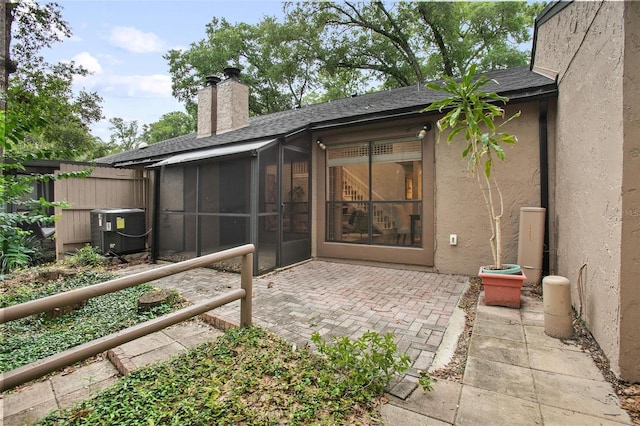 940 Douglas Ave Unit 189, Altamonte Springs, FL 32714 - back of house featuring a chimney, roof with shingles, a patio, a sunroom, and stucco siding
