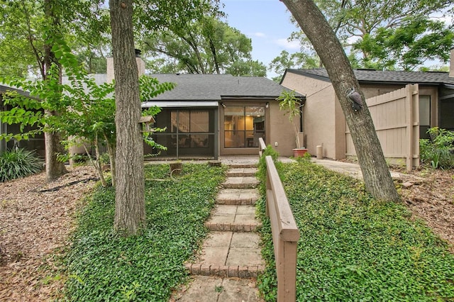 940 Douglas Ave Unit 189, Altamonte Springs, FL 32714 - back of property with a sunroom, a chimney, a shingled roof, and stucco siding