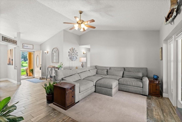 3132 Mango Tree Dr, Edgewater, FL 32141 - living area with wood finished floors, a ceiling fan, a textured ceiling, and lofted ceiling