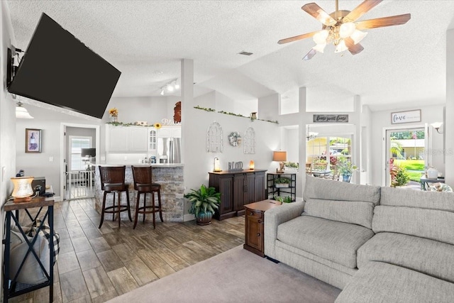 3132 Mango Tree Dr, Edgewater, FL 32141 - living area featuring lofted ceiling, a textured ceiling, wood finished floors, and a ceiling fan