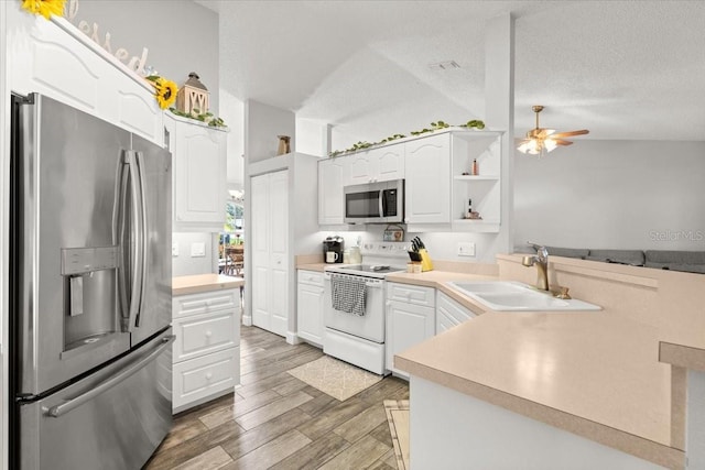 3132 Mango Tree Dr, Edgewater, FL 32141 - kitchen featuring appliances with stainless steel finishes, a ceiling fan, white cabinets, light countertops, and a textured ceiling