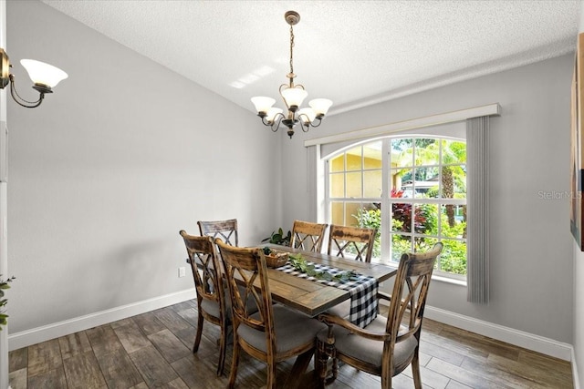 3132 Mango Tree Dr, Edgewater, FL 32141 - dining room with a chandelier, wood finished floors, and a textured ceiling