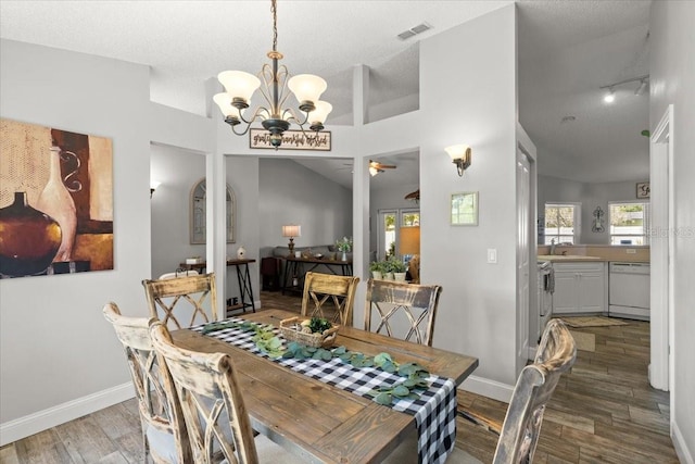 3132 Mango Tree Dr, Edgewater, FL 32141 - dining room with wood finished floors, a chandelier, a ceiling fan, and track lighting