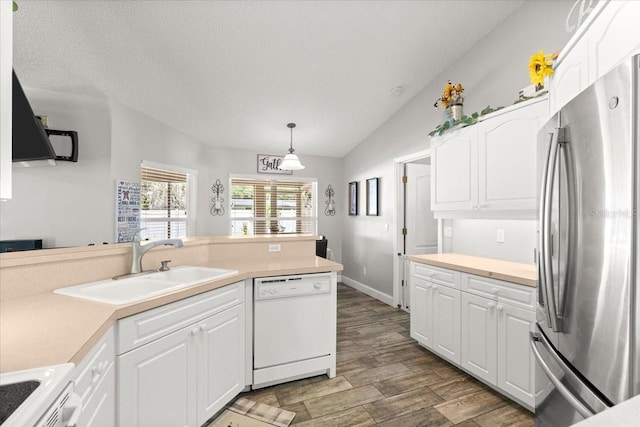 3132 Mango Tree Dr, Edgewater, FL 32141 - kitchen featuring white appliances, white cabinets, light countertops, wood finished floors, and lofted ceiling