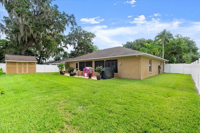 3132 Mango Tree Dr, Edgewater, FL 32141 - back of property with a fenced backyard, stucco siding, a storage unit, and a patio