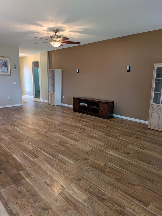 223 W Fiesta Key Loop, Deland, FL 32720 - unfurnished living room featuring wood finished floors and a ceiling fan