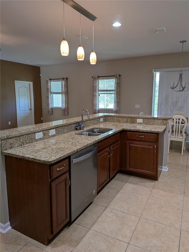 223 W Fiesta Key Loop, Deland, FL 32720 - kitchen with stainless steel dishwasher, hanging light fixtures, light stone countertops, light tile patterned floors, and recessed lighting
