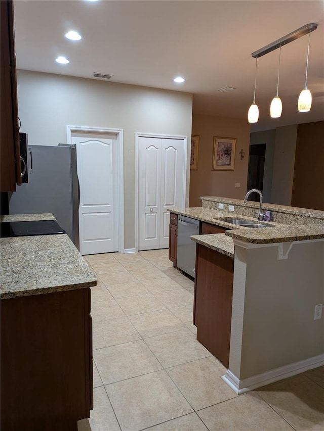 223 W Fiesta Key Loop, Deland, FL 32720 - kitchen featuring appliances with stainless steel finishes, recessed lighting, light tile patterned floors, pendant lighting, and a breakfast bar area