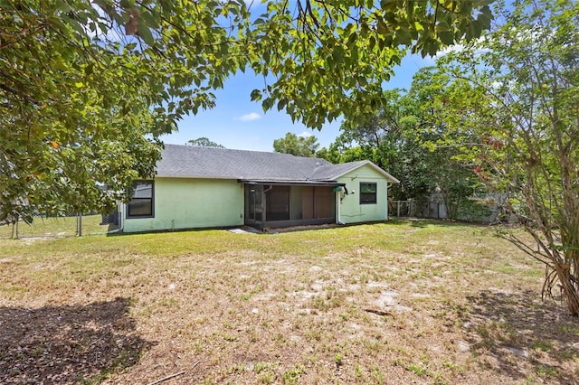 1018 E Gaucho Cir, Deltona, FL 32725 - rear view of house with a sunroom, a shingled roof, and stucco siding