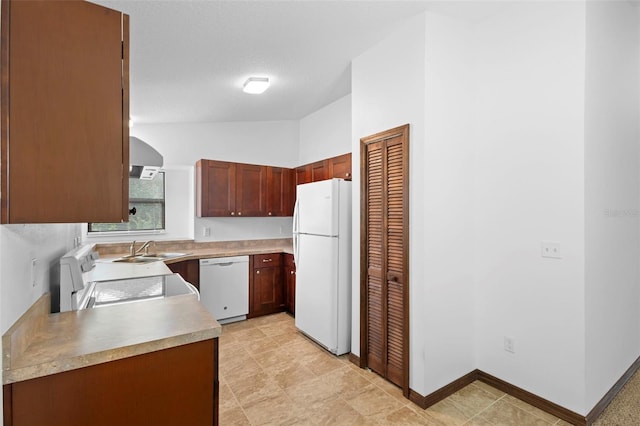 1018 E Gaucho Cir, Deltona, FL 32725 - kitchen with white appliances, a sink, light countertops, baseboards, and lofted ceiling