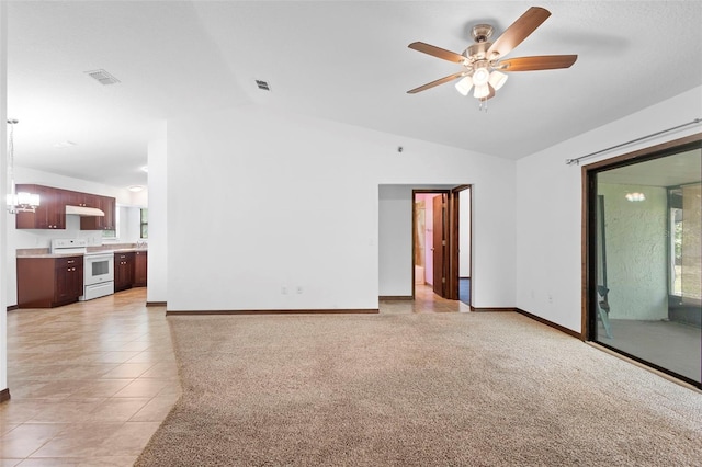 1018 E Gaucho Cir, Deltona, FL 32725 - unfurnished living room featuring lofted ceiling, a ceiling fan, baseboards, and light tile patterned floors