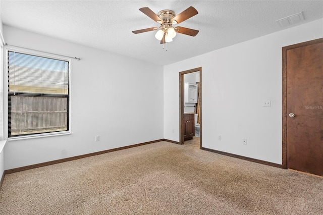 1018 E Gaucho Cir, Deltona, FL 32725 - empty room featuring light colored carpet, a ceiling fan, a textured ceiling, and baseboards