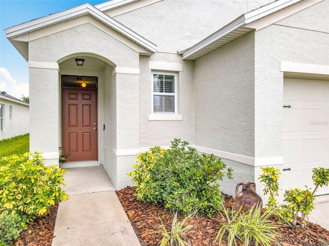 422 Armoyan Way, New Smyrna Beach, FL 32168 - doorway to property with stucco siding