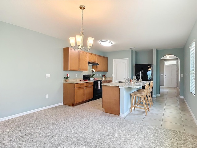 422 Armoyan Way, New Smyrna Beach, FL 32168 - kitchen featuring black appliances, arched walkways, a sink, light tile patterned flooring, and baseboards