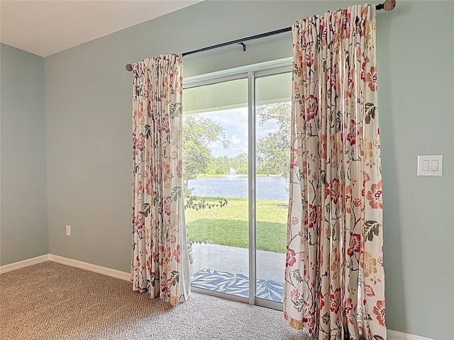 422 Armoyan Way, New Smyrna Beach, FL 32168 - doorway to outside featuring carpet, a water view, and baseboards
