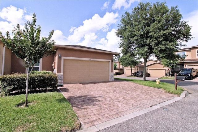 201 Walter Stevens Way, Deland, FL 32724 - view of front of house with stucco siding, decorative driveway, an attached garage, and stone siding