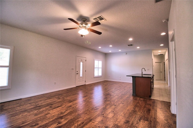 201 Walter Stevens Way, Deland, FL 32724 - unfurnished living room featuring ceiling fan, dark wood-style flooring, a sink, recessed lighting, and a textured ceiling