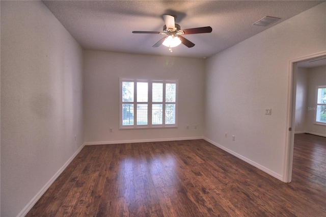 201 Walter Stevens Way, Deland, FL 32724 - spare room with dark wood-type flooring, a ceiling fan, baseboards, and a textured ceiling