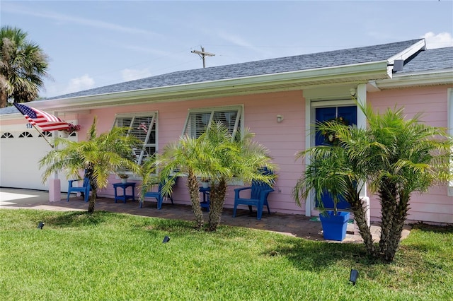 179 Ann Rustin Dr S, Ormond Beach, FL 32176 - view of front of home featuring a front yard, a shingled roof, and an attached garage