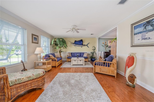 179 Ann Rustin Dr S, Ormond Beach, FL 32176 - living area featuring a ceiling fan, wood finished floors, crown molding, and baseboards
