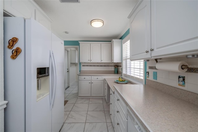 179 Ann Rustin Dr S, Ormond Beach, FL 32176 - kitchen featuring white refrigerator with ice dispenser, light countertops, white cabinetry, decorative backsplash, and light marble finish flooring
