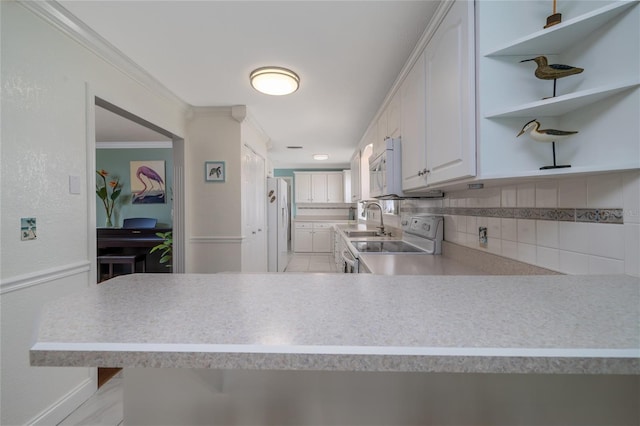 179 Ann Rustin Dr S, Ormond Beach, FL 32176 - kitchen with white appliances, a sink, tasteful backsplash, crown molding, and light countertops