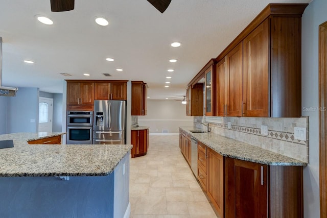 65 Sycamore Cir, Ormond Beach, FL 32174 - kitchen with stainless steel appliances, a ceiling fan, a sink, baseboards, and recessed lighting