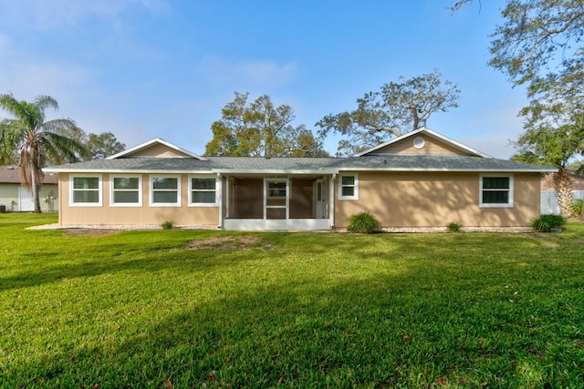 65 Sycamore Cir, Ormond Beach, FL 32174 - rear view of house with a sunroom, a lawn, and roof with shingles
