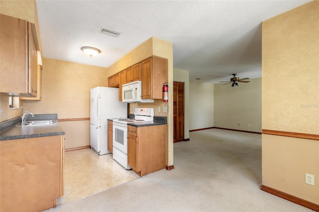 840 Center Ave Unit 280, Daytona Beach, FL 32117 - kitchen featuring white appliances, ceiling fan, dark countertops, and brown cabinetry