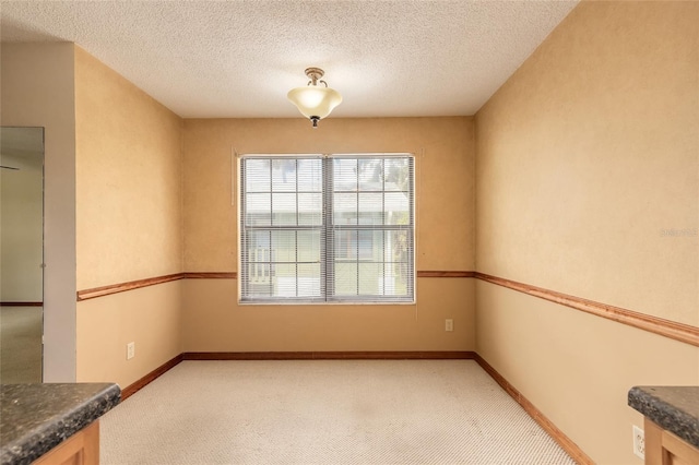 840 Center Ave Unit 280, Daytona Beach, FL 32117 - unfurnished dining area with light carpet and a textured ceiling