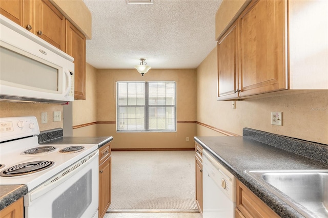 840 Center Ave Unit 280, Daytona Beach, FL 32117 - kitchen with white appliances, dark countertops, brown cabinets, light colored carpet, and a textured ceiling