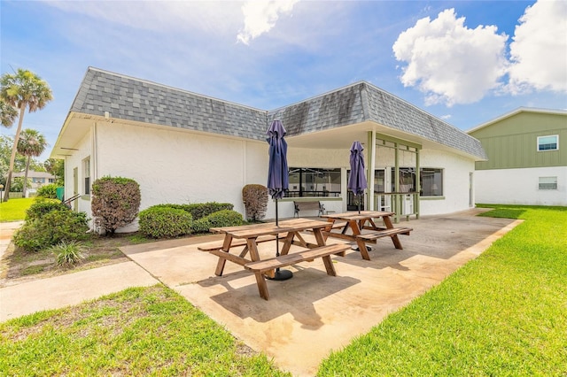 840 Center Ave Unit 280, Daytona Beach, FL 32117 - back of house with mansard roof, roof with shingles, a patio area, and stucco siding