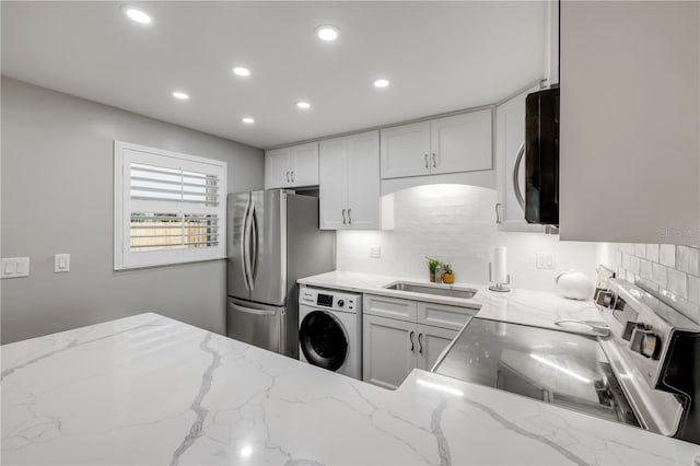 10 Lynnhurst Dr Unit 1050, Ormond Beach, FL 32176 - kitchen with washer / clothes dryer, range with electric cooktop, recessed lighting, tasteful backsplash, and freestanding refrigerator
