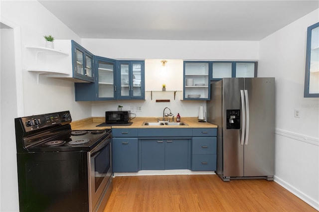 18 S Shell Rd, Debary, FL 32713 - kitchen featuring black appliances, open shelves, a sink, blue cabinetry, and light wood-type flooring