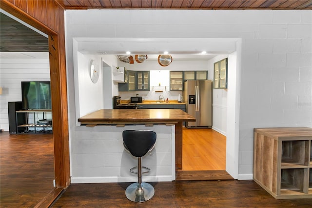 18 S Shell Rd, Debary, FL 32713 - kitchen with stainless steel refrigerator with ice dispenser, wood counters, dark wood-style floors, glass insert cabinets, and a peninsula