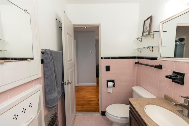18 S Shell Rd, Debary, FL 32713 - half bathroom with tile walls, toilet, vanity, and wainscoting