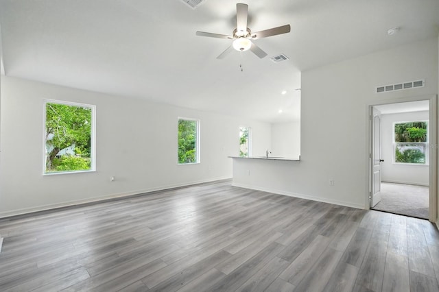 1161 Kenway Ave, Deltona, FL 32738 - unfurnished living room featuring healthy amount of natural light, ceiling fan, wood finished floors, and baseboards