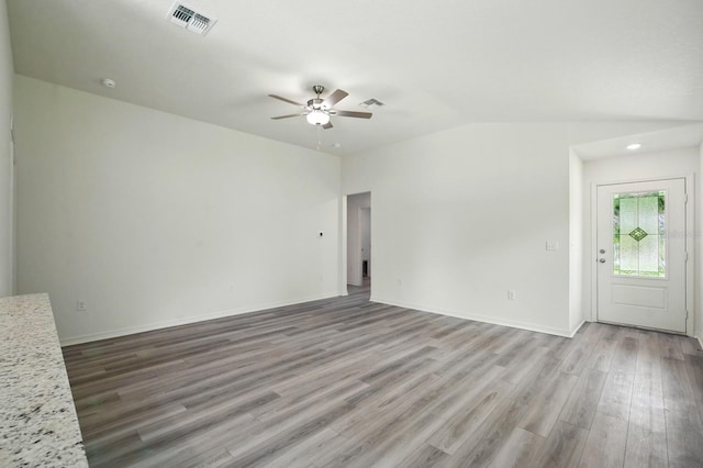 1161 Kenway Ave, Deltona, FL 32738 - unfurnished living room featuring ceiling fan, wood finished floors, vaulted ceiling, and baseboards