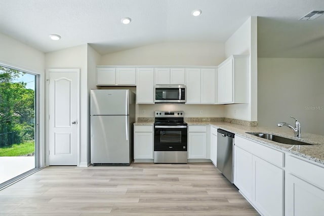 1161 Kenway Ave, Deltona, FL 32738 - kitchen featuring stainless steel appliances, a sink, lofted ceiling, light stone counters, and white cabinets
