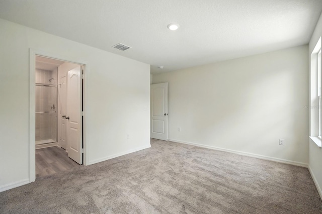 1161 Kenway Ave, Deltona, FL 32738 - unfurnished bedroom featuring carpet, baseboards, recessed lighting, and connected bathroom