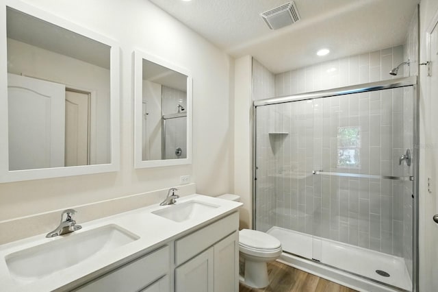 1161 Kenway Ave, Deltona, FL 32738 - full bath with a stall shower, double vanity, toilet, wood finished floors, and recessed lighting