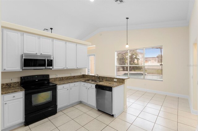 2263 Catbriar Way, Oviedo, FL 32765 - kitchen with appliances with stainless steel finishes, lofted ceiling, a peninsula, white cabinetry, and dark stone countertops