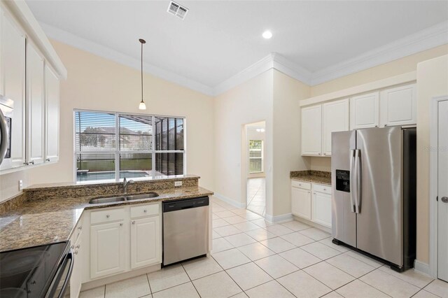 2263 Catbriar Way, Oviedo, FL 32765 - kitchen featuring appliances with stainless steel finishes, ornamental molding, plenty of natural light, white cabinets, and lofted ceiling