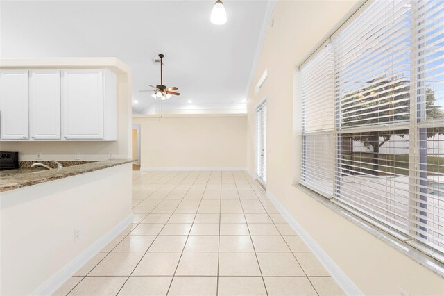 2263 Catbriar Way, Oviedo, FL 32765 - kitchen featuring a ceiling fan, stove, light tile patterned flooring, white cabinets, and light stone counters